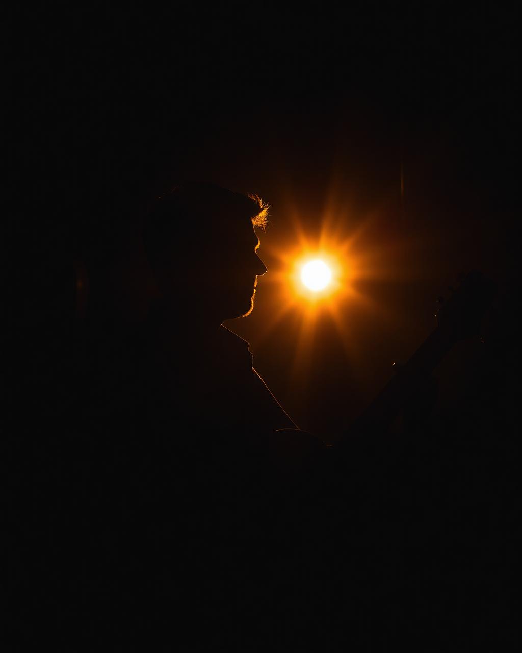 Silhouette of Tom Kevins with a guitar